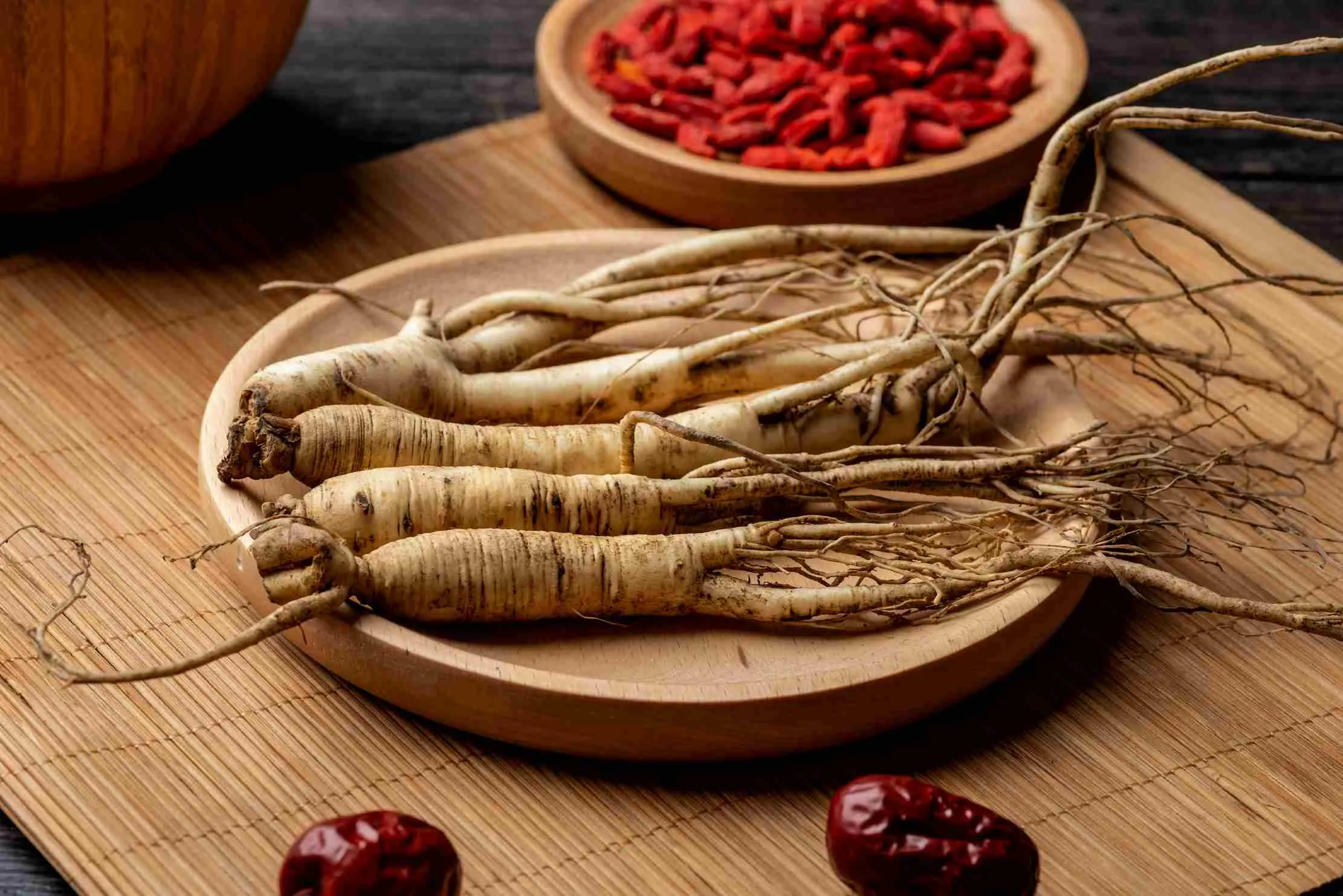 Fresh whole Panax ginseng roots arranged on a natural surface — a traditional Asian medicinal herb